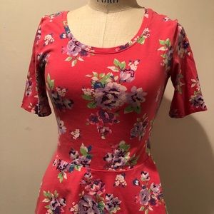 Coral Floral peplum hem top.